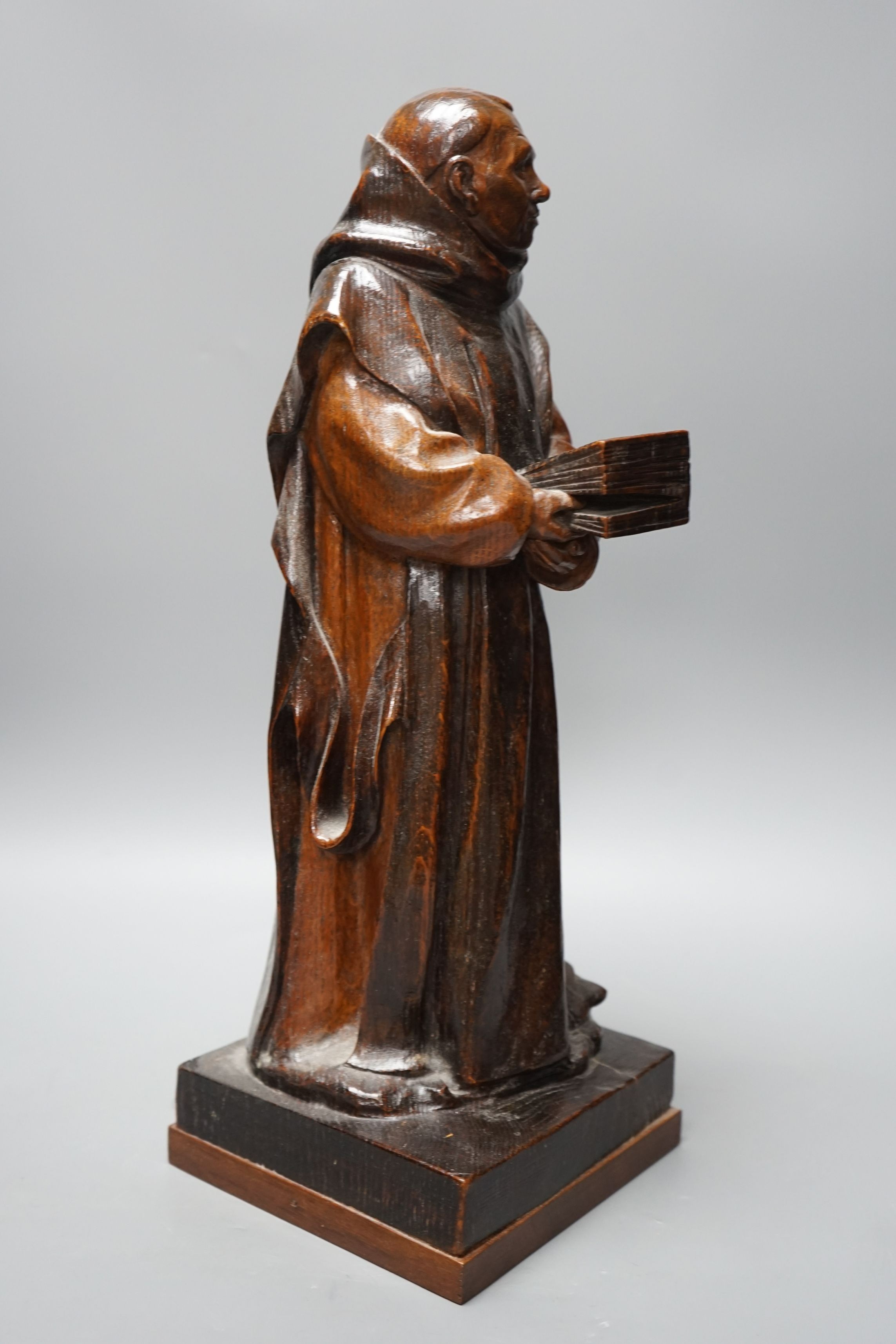 A carved wooden figure of a friar, 48cms high